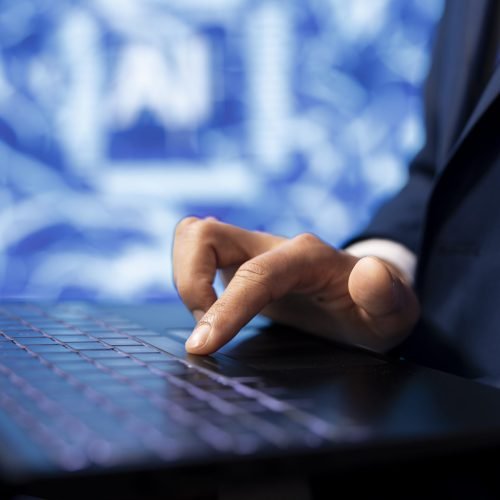 IT specialist coding on laptop, programming artificial intelligence computing simulating human brain. Programmer using technology gear to build AI machine learning algorithms, close up shot